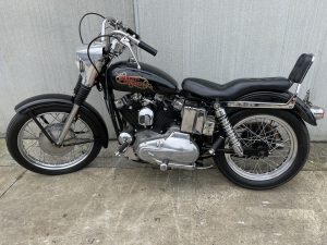 a Black 017 harley davidson sportster 69 01 motorcycle parked on concrete