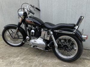 a Black 017 harley davidson sportster 69 02 motorcycle parked on concrete