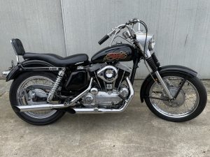 a Black 017 harley davidson sportster 69 05 motorcycle parked on concrete