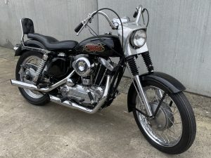 a Black 017 harley davidson sportster 69 06 motorcycle parked on concrete
