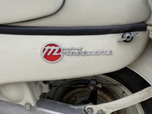 a close up of a white 018 motobecane 125 03 motorcycle